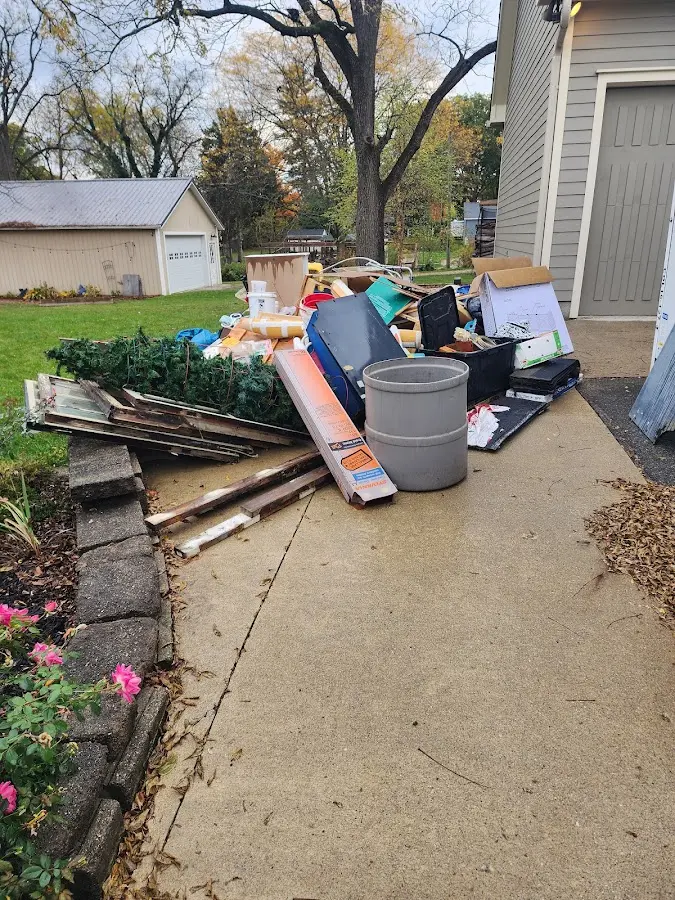 Dumpster being loaded with debris for Roofing Dumpster Rental in Gainesville